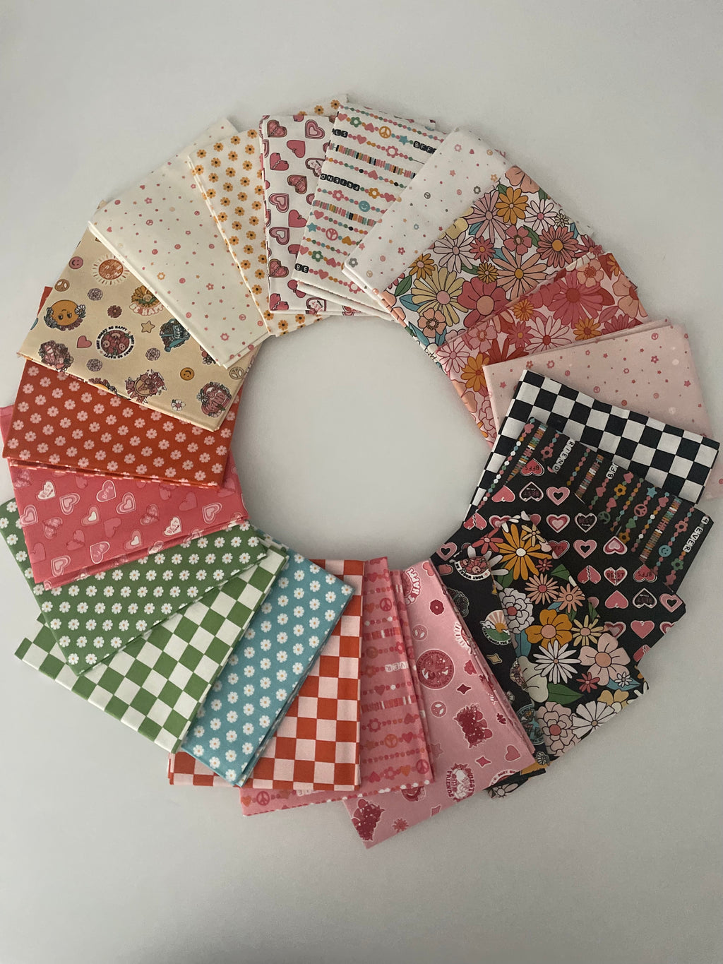 Circular arrangement of patterned fabric squares on a light gray background