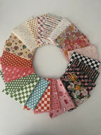 Circular arrangement of patterned fabric squares on a light gray background