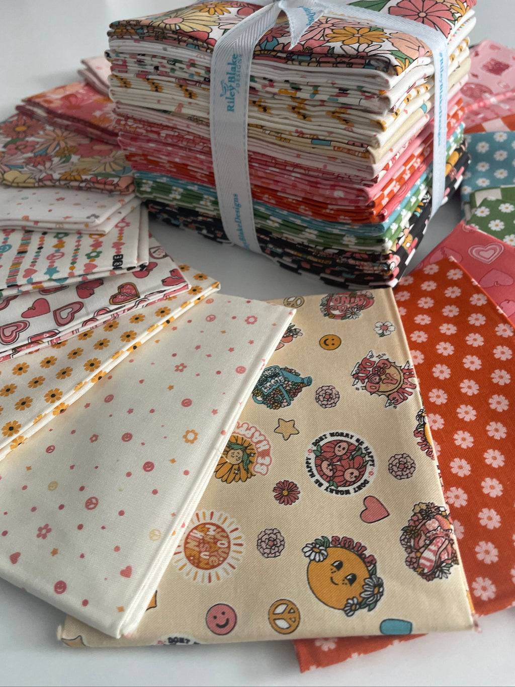 Stack of patterned fabric squares on a white surface