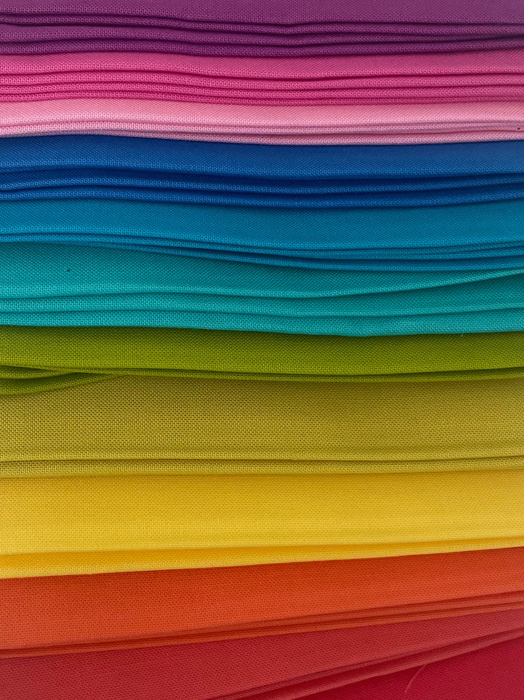 Stack of colorful folded paper sheets on a white background