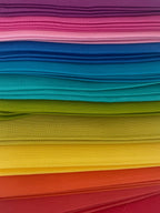 Stack of colorful folded paper sheets on a white background