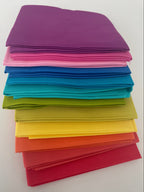 Stack of colorful folded paper sheets on a white background