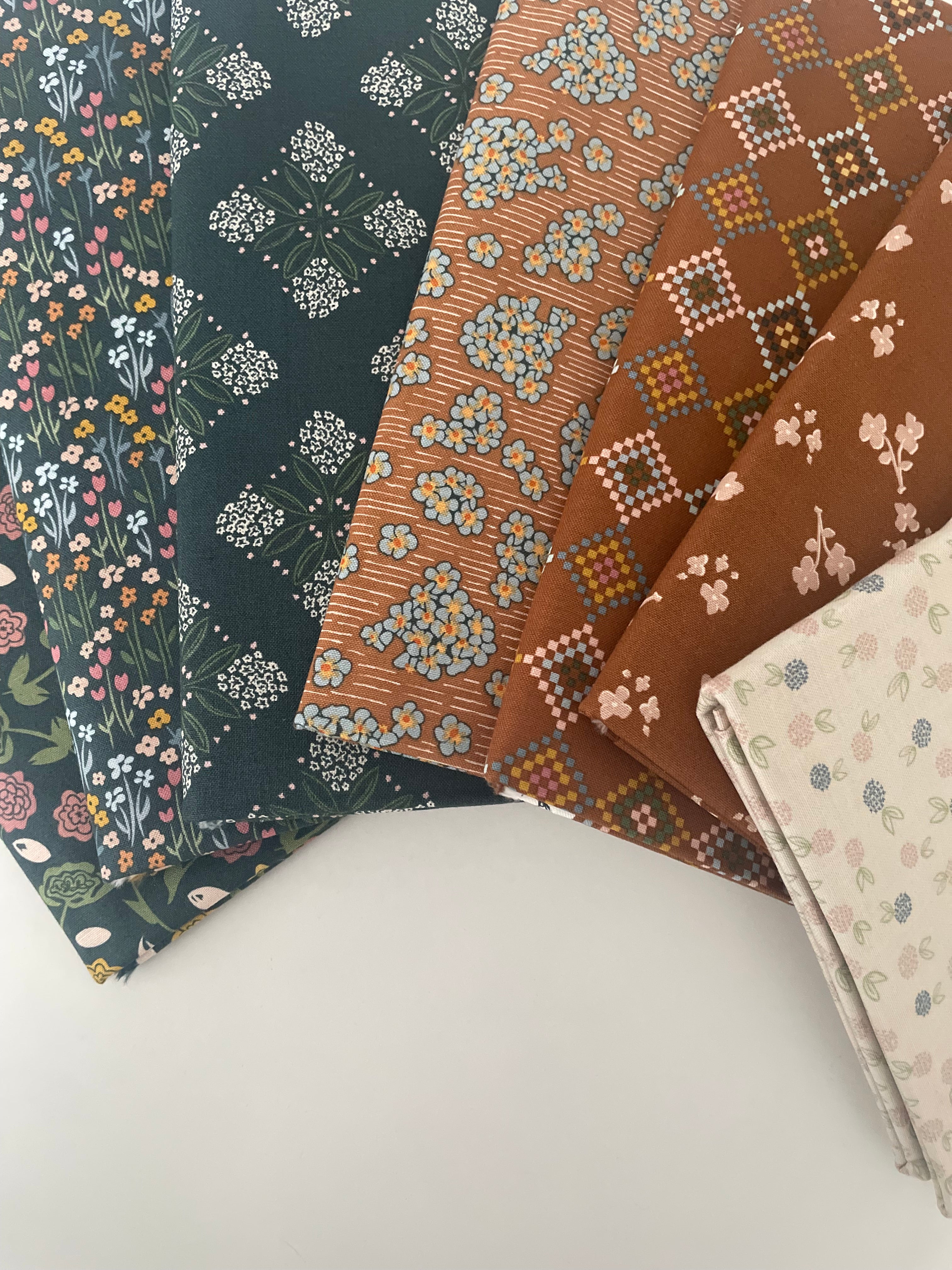 Three pieces of patterned fabric on a white surface