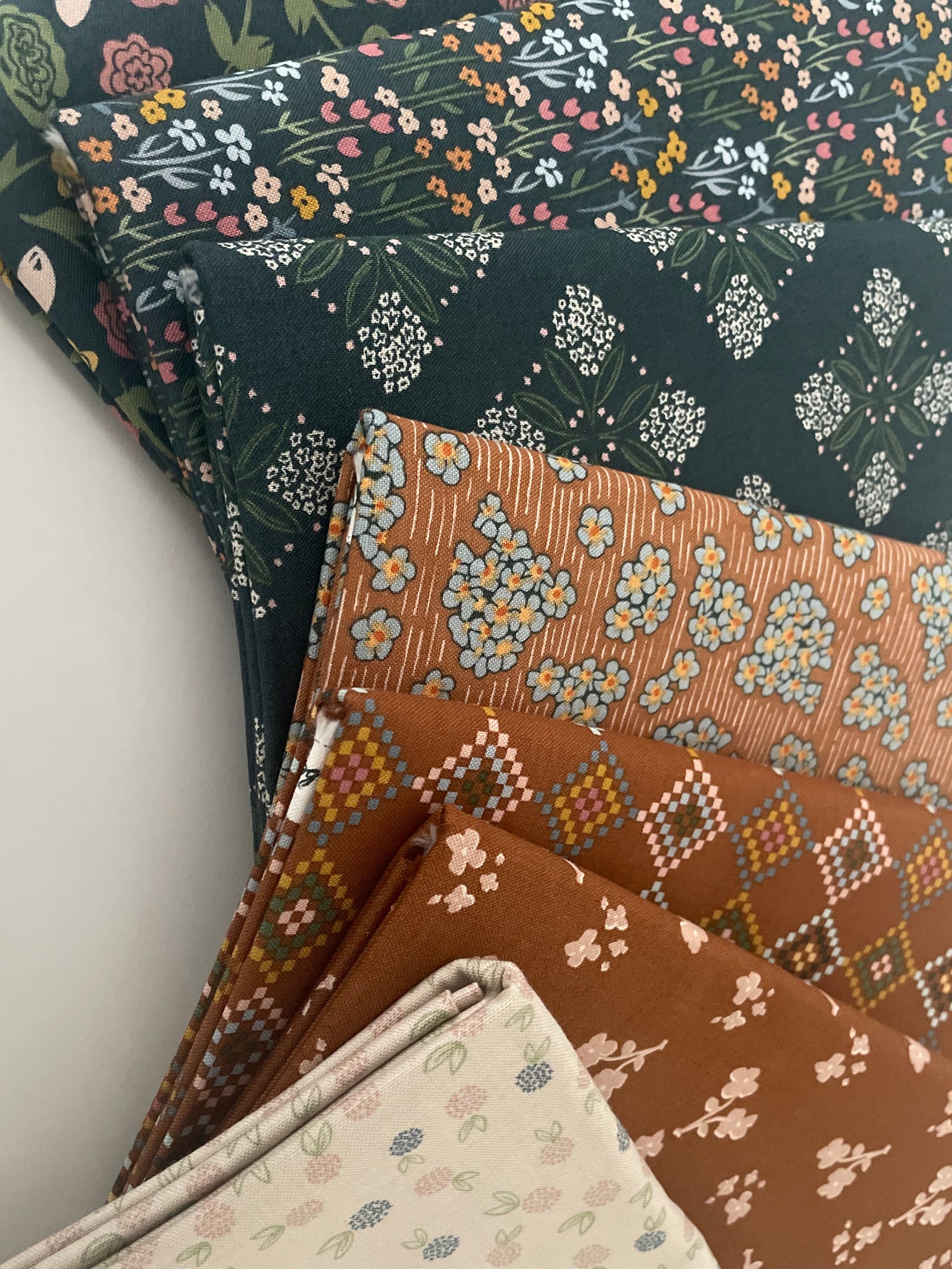 Collection of patterned fabric swatches on a light gray background