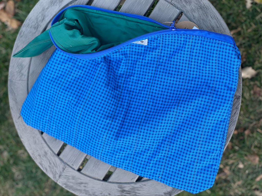 Blue checkered blanket on a wooden chair outdoors