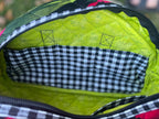 Close-up of a green bag interior with checkered lining