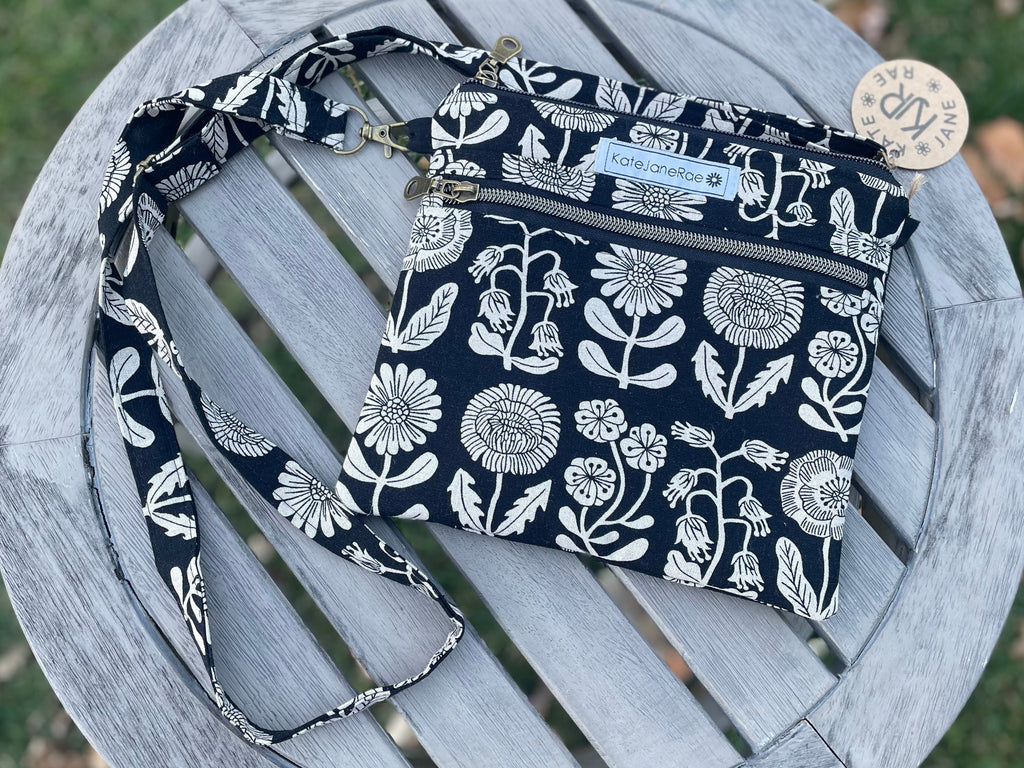 Navy blue fabric with white floral pattern on a wooden chair outdoors