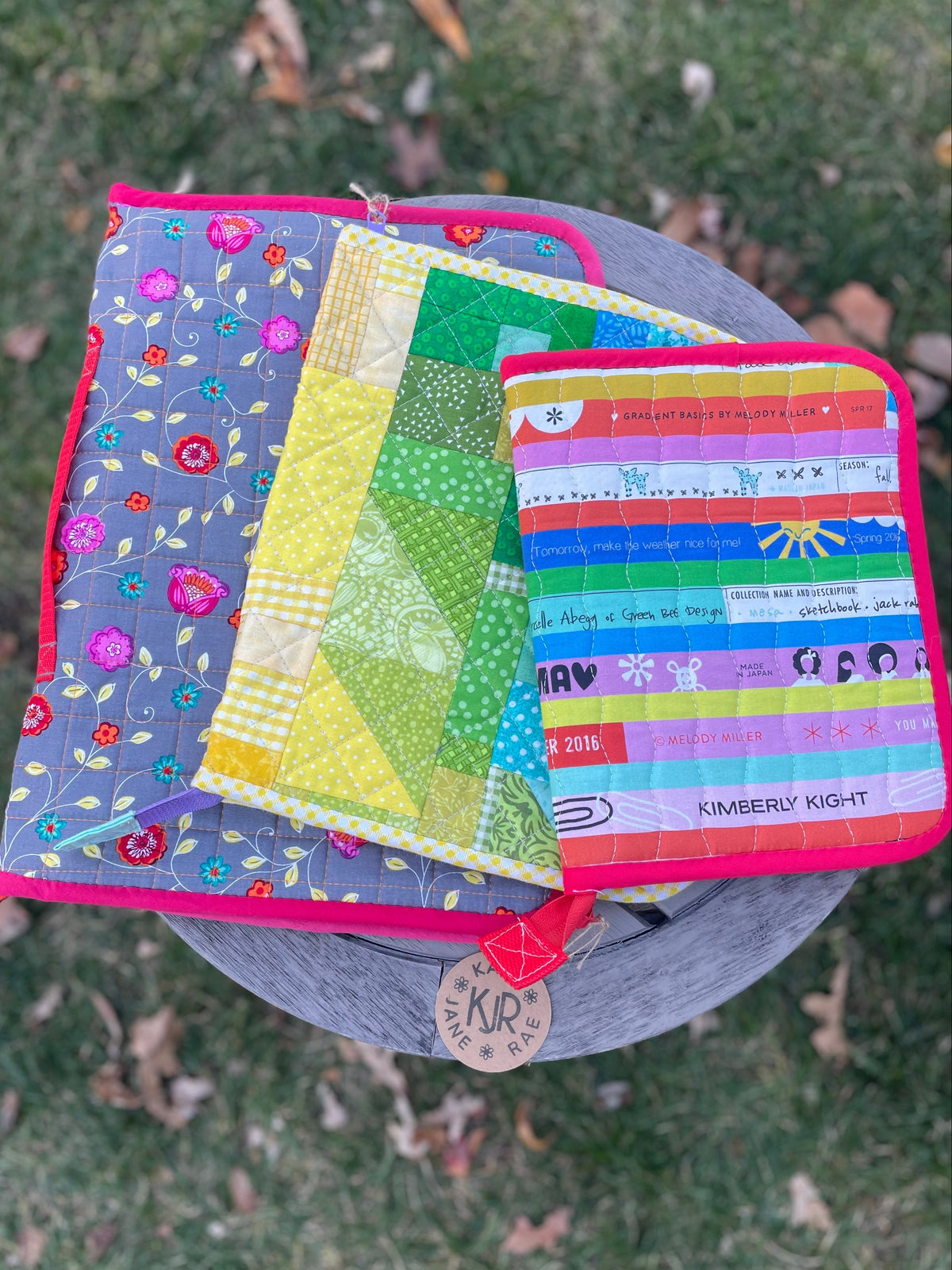 Colorful quilted items on a grassy background