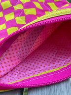 Close-up of a pink and yellow textured fabric with a zipper