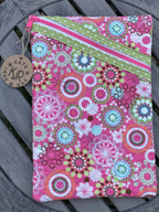 Floral patterned pouch with a zipper on a wooden surface