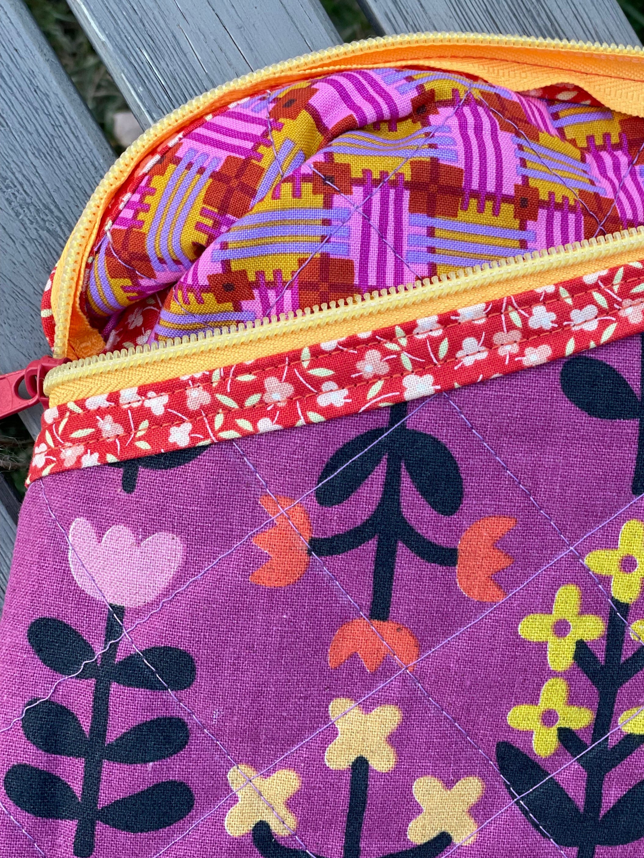 Purple fabric with floral patterns on a wooden surface