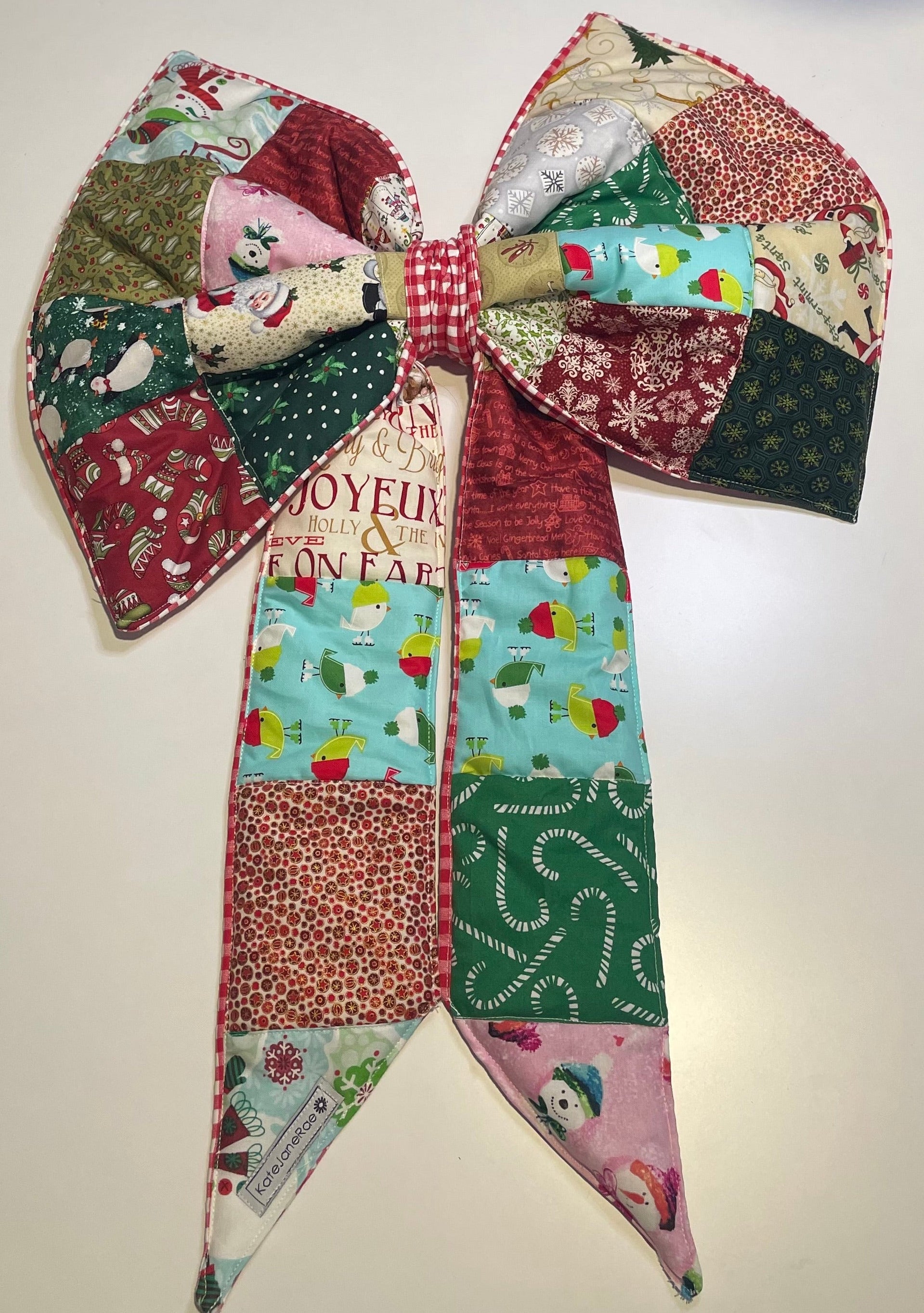 Colorful patchwork bow with festive patterns on a light background