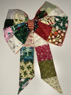 Patchwork bow with Christmas-themed fabric on a white background