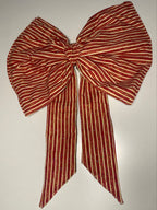 Red and white striped bow on a white background