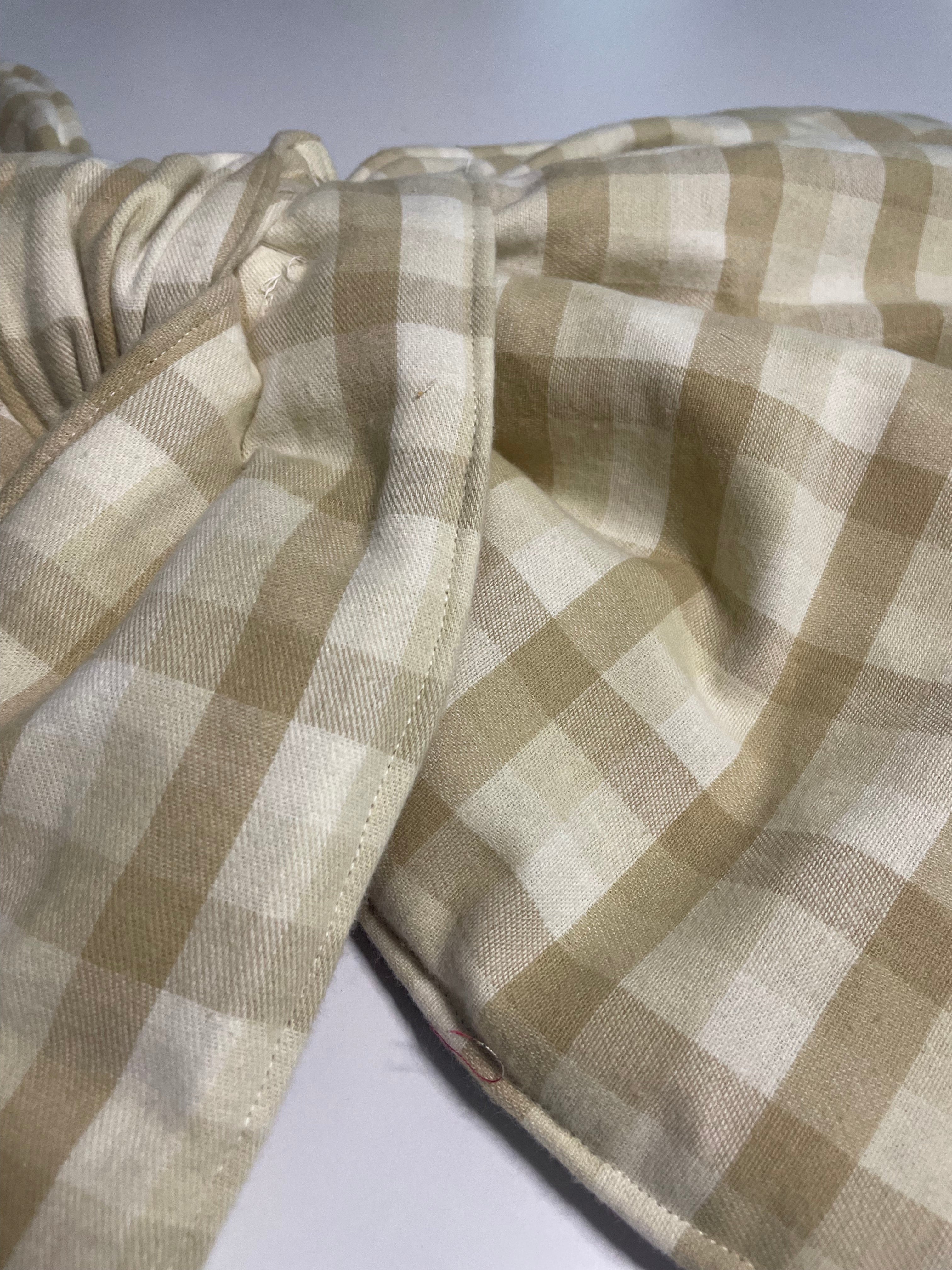 Close-up of a beige and white checkered fabric with a blurred background