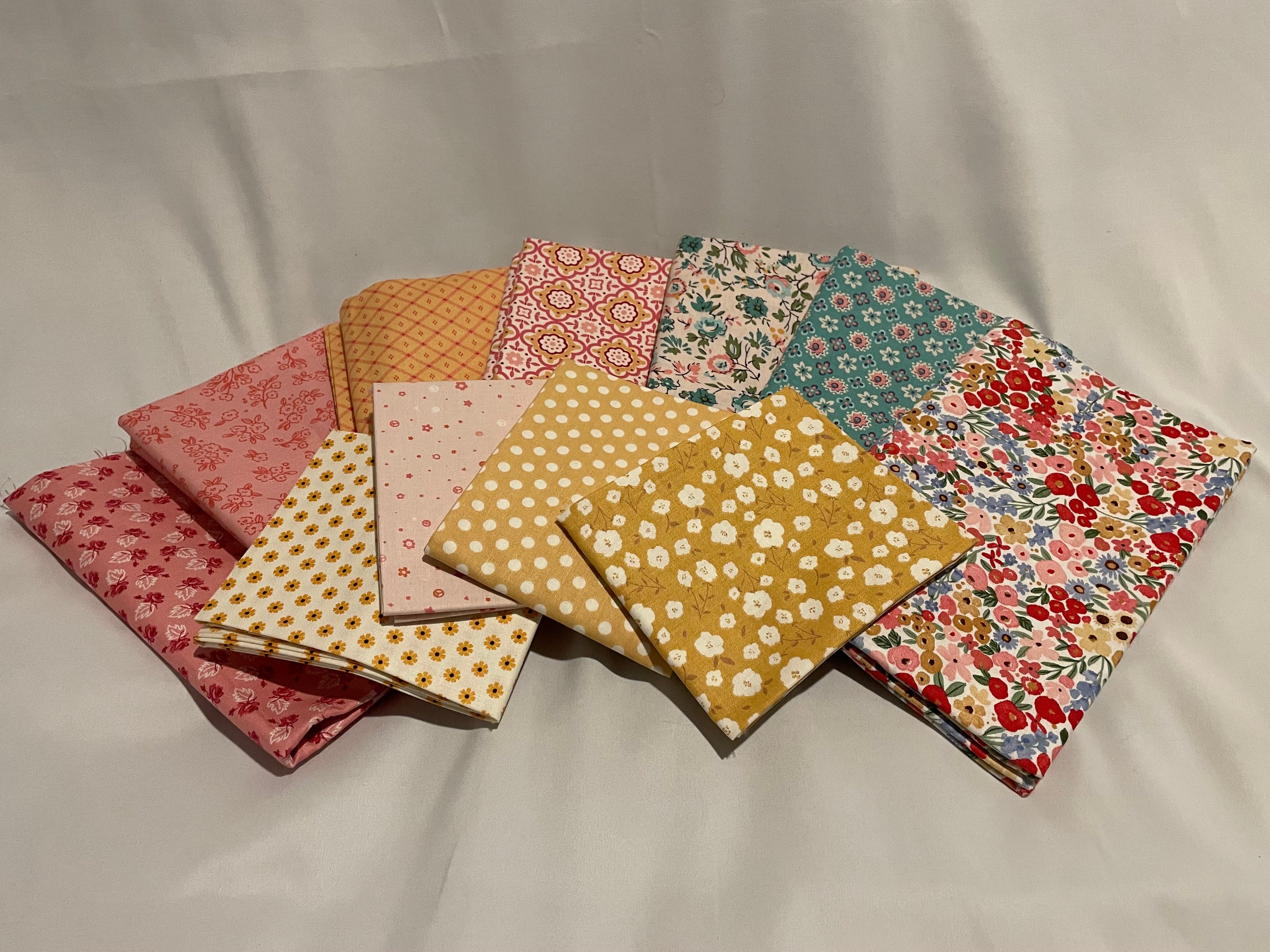 Collection of patterned fabric squares on a plain background