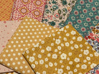 Collection of various patterned fabric squares on a plain background