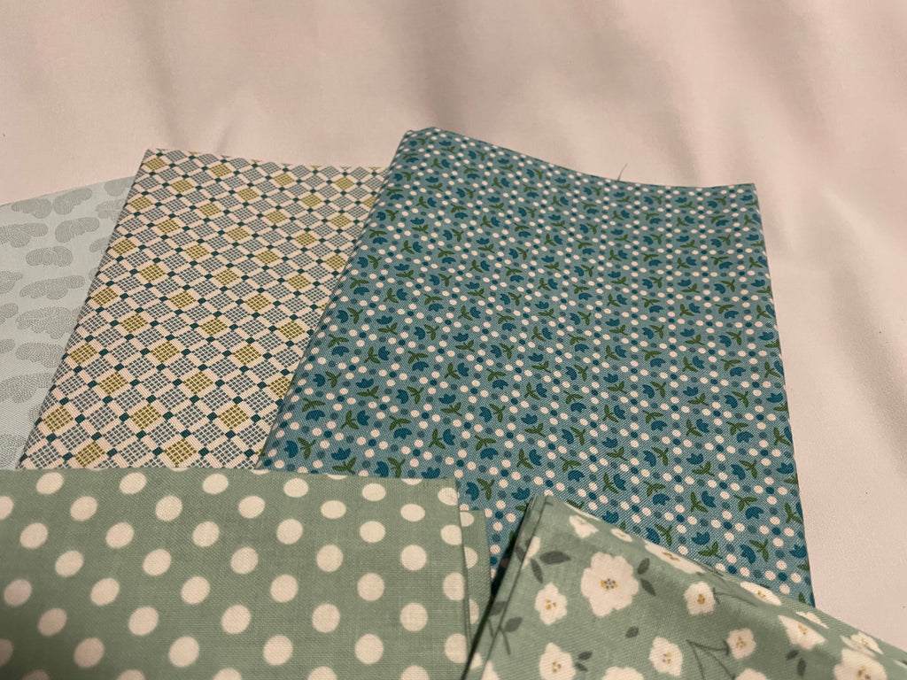 Four pieces of patterned fabric on a light background