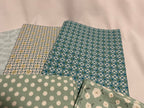 Four pieces of patterned fabric on a light background