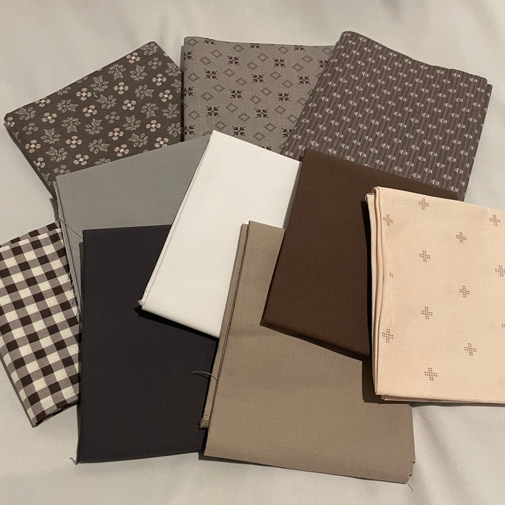 Collection of fabric swatches in various patterns and colors on a neutral background