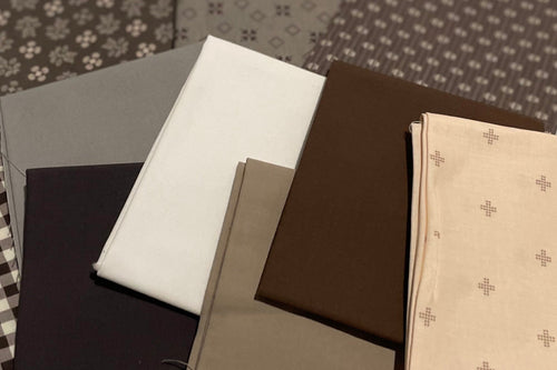 Collection of fabric swatches in various patterns and colors on a light gray background