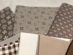 Collection of fabric swatches with various patterns on a neutral background