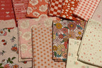 Collection of patterned paper stacks on a plain background