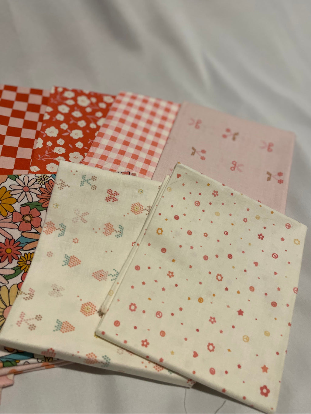 Collection of patterned fabric samples on a plain background