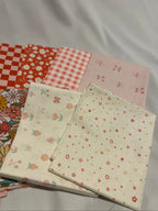 Collection of patterned fabric samples on a plain background