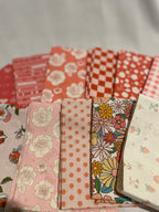 Collection of colorful fabric swatches with floral and polka dot patterns.
