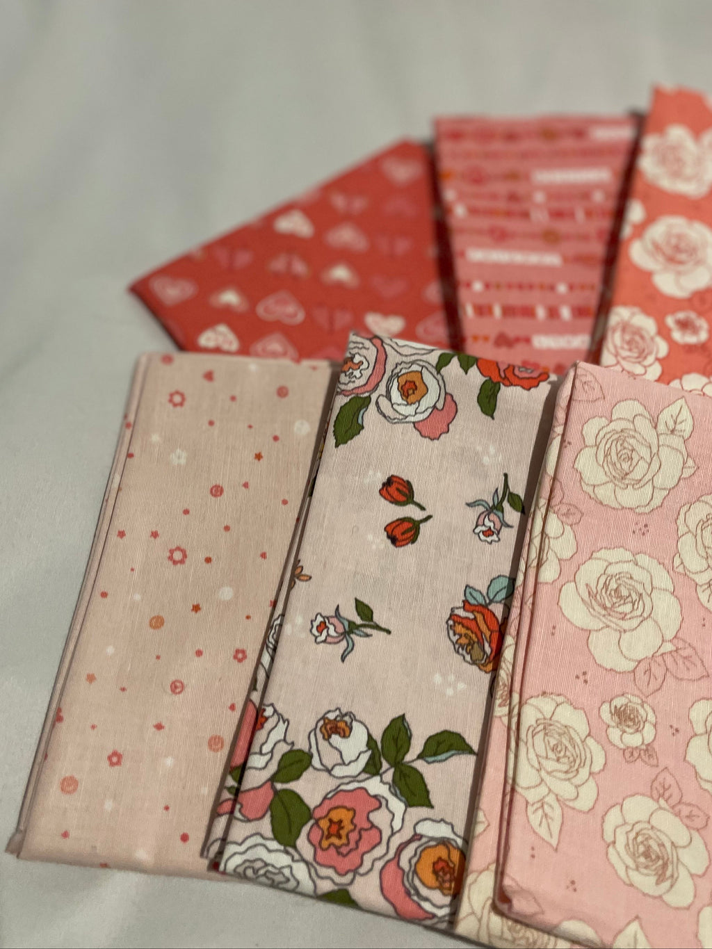 Set of fabric swatches with floral and patterned designs on a light background