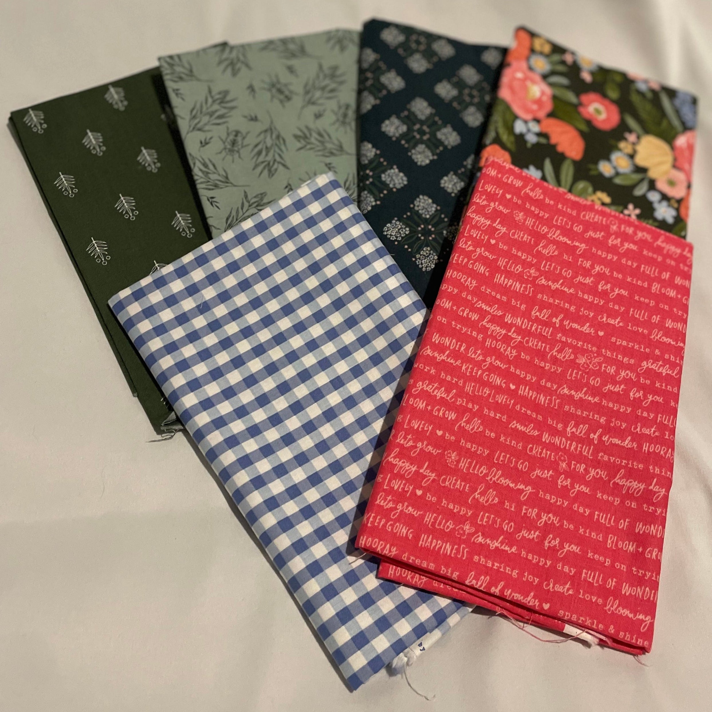 Five fabric swatches with different patterns on a white background