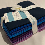 Pack of colorful fabric strips with a visible brand tag on a beige background