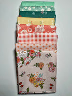 Collection of folded fabric samples with various patterns on a gray background