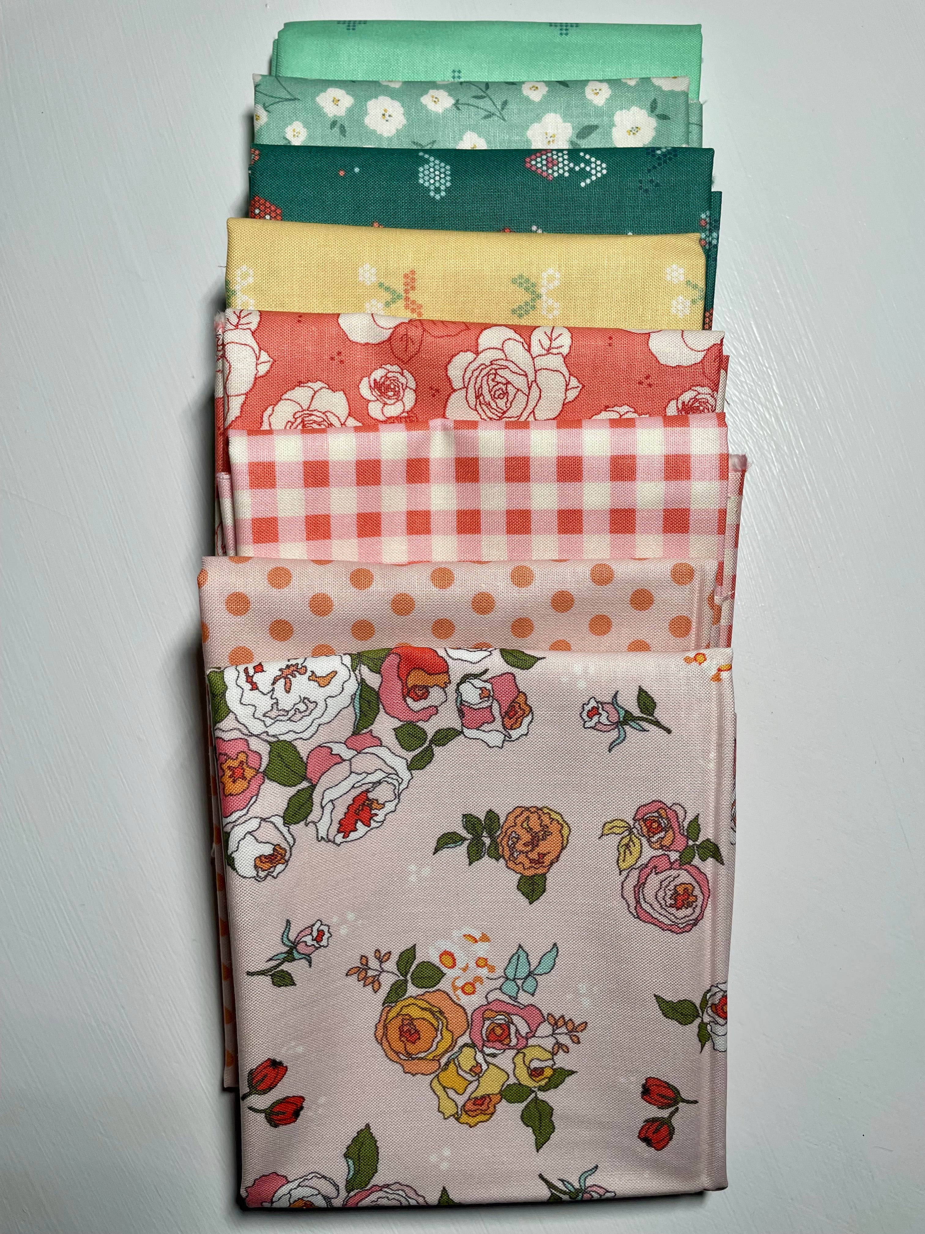 Collection of folded fabric samples with various patterns on a gray background